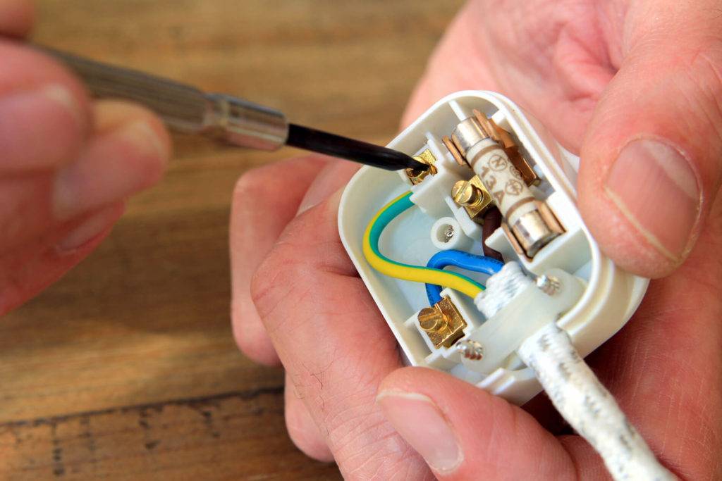 electrician fixing a plug